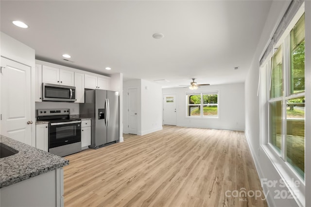 212 N Correll St, Landis, NC 28025 - kitchen featuring appliances with stainless steel finishes, white cabinetry, light wood finished floors, light stone countertops, and recessed lighting