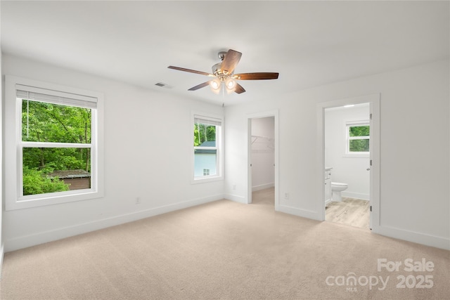 212 N Correll St, Landis, NC 28025 - unfurnished bedroom featuring light carpet, a spacious closet, baseboards, ensuite bath, and a closet