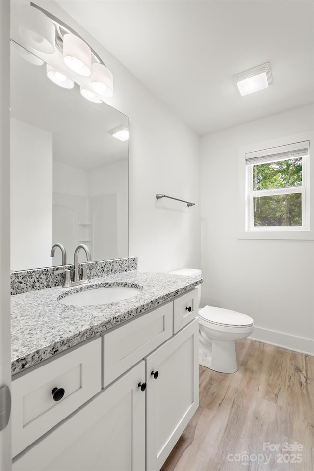 212 N Correll St, Landis, NC 28025 - bathroom with wood finished floors, toilet, vanity, and baseboards