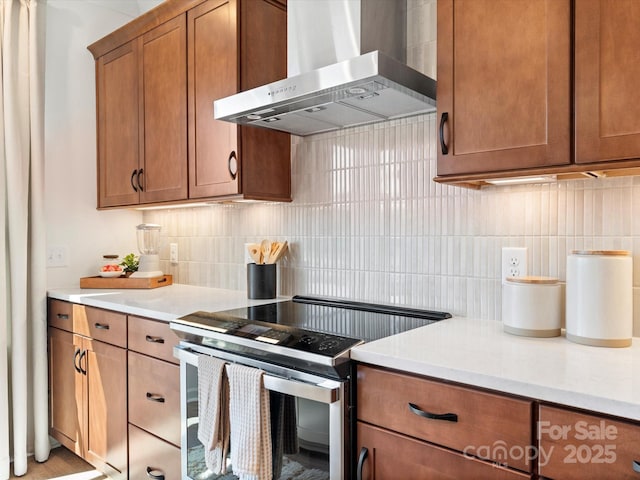 5508 Swaling St, Charlotte, NC 28217 - kitchen with wall chimney exhaust hood, electric range, tasteful backsplash, and light countertops