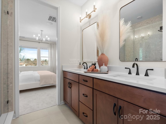 5508 Swaling St, Charlotte, NC 28217 - ensuite bathroom featuring double vanity, a chandelier, tile patterned flooring, and a shower with door