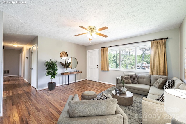 1515 Fairway Acres Rd, Lenoir, NC 28645 - living area featuring wood finished floors, ceiling fan, and a textured ceiling