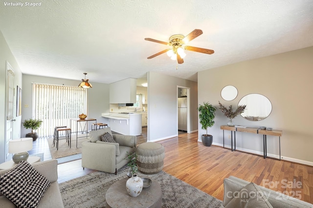 1515 Fairway Acres Rd, Lenoir, NC 28645 - living area featuring ceiling fan, light wood-style flooring, and a textured ceiling