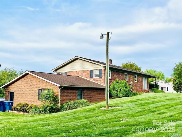 1515 Fairway Acres Rd, Lenoir, NC 28645 - view of side of property with brick siding, a lawn, a chimney, and roof with shingles