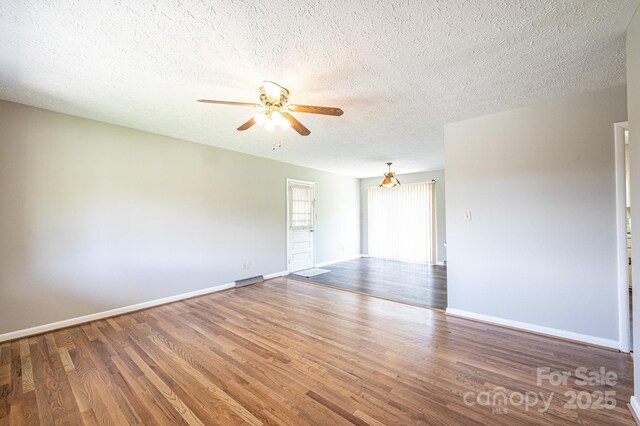 1515 Fairway Acres Rd, Lenoir, NC 28645 - unfurnished room with a ceiling fan, wood finished floors, and a textured ceiling