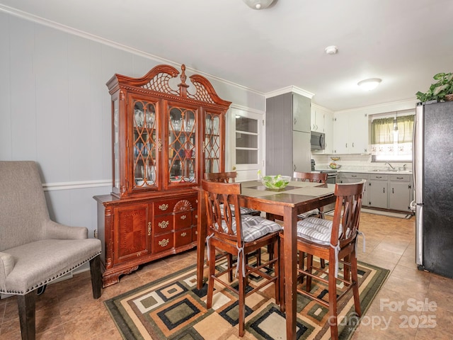 5629 Ruth Dr, Charlotte, NC 28215 - dining area with light tile patterned floors, crown molding, and a decorative wall
