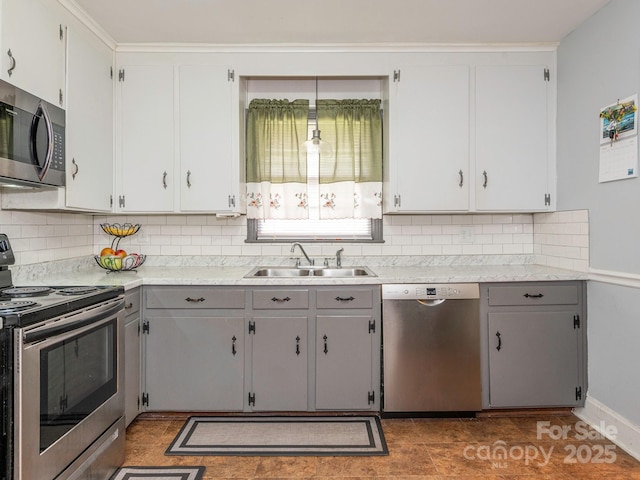 5629 Ruth Dr, Charlotte, NC 28215 - kitchen featuring appliances with stainless steel finishes, a sink, tasteful backsplash, light countertops, and gray cabinets