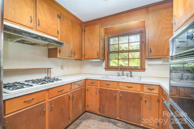 3526 Craig Ave, Charlotte, NC 28211 - kitchen with white gas stovetop, a sink, under cabinet range hood, oven, and light countertops
