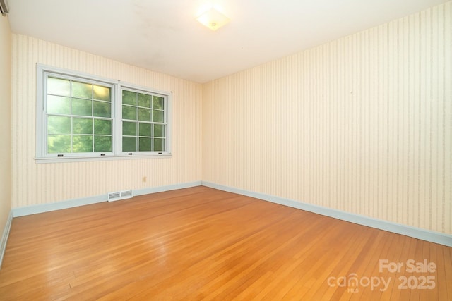 3526 Craig Ave, Charlotte, NC 28211 - empty room featuring light wood finished floors, baseboards, and wallpapered walls