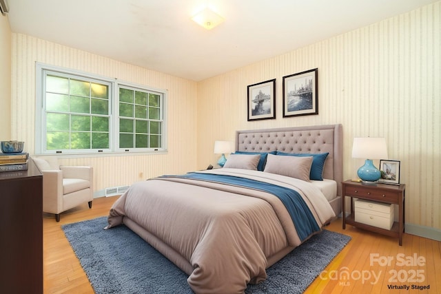 3526 Craig Ave, Charlotte, NC 28211 - bedroom featuring wallpapered walls, light wood-type flooring, and baseboards