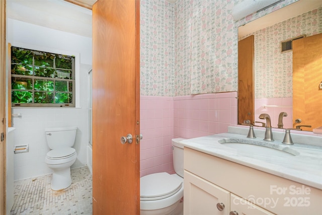 3526 Craig Ave, Charlotte, NC 28211 - full bath with toilet, tile walls, vanity, wallpapered walls, and wainscoting