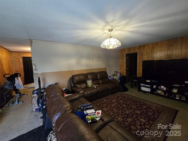 116 E Graves St, Candor, NC 27229 - living area with wood walls, a chandelier, and a textured ceiling