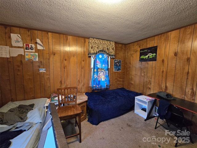 116 E Graves St, Candor, NC 27229 - bedroom featuring carpet floors, a textured ceiling, and wood walls