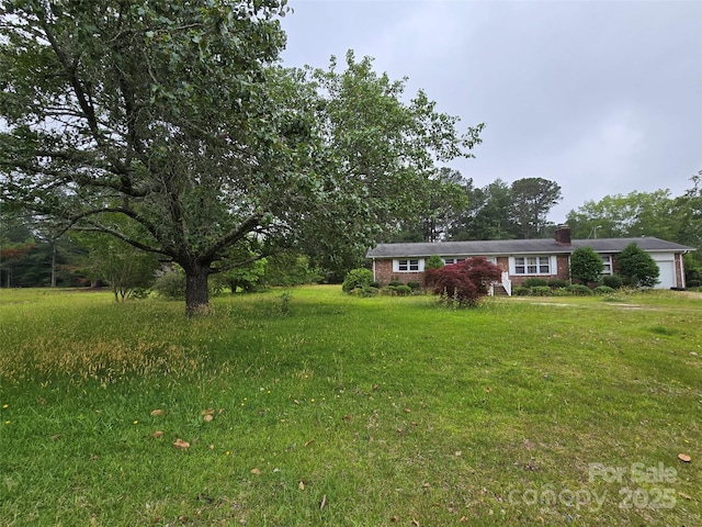 116 E Graves St, Candor, NC 27229 - view of green lawn featuring an attached garage