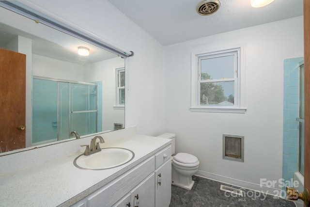 bathroom with a shower with door, vanity, toilet, baseboards, and tile patterned flooring