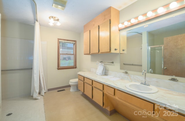 full bath with a stall shower, vanity, toilet, and baseboards