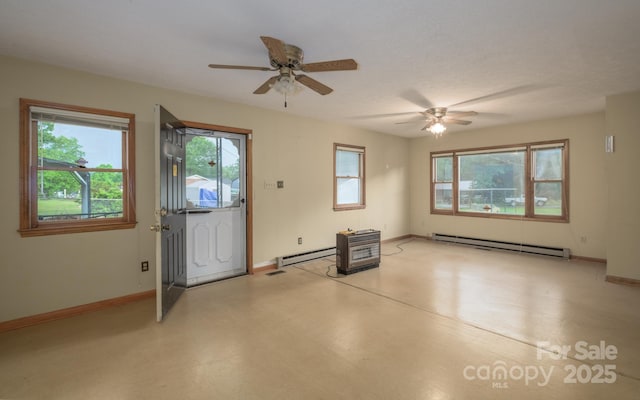 empty room with a baseboard heating unit, healthy amount of natural light, and baseboards