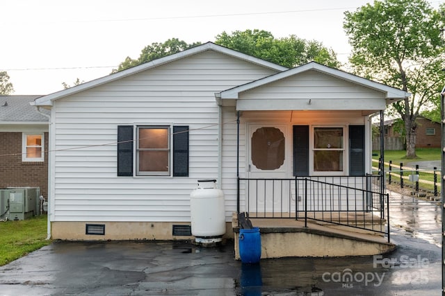 bungalow-style house featuring crawl space, a porch, and central air condition unit