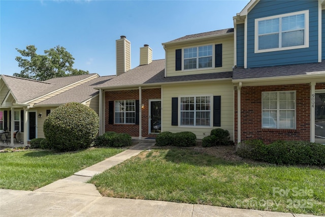 9006 Four Mile Creek Rd, Charlotte, NC 28277 - view of property featuring brick siding, a chimney, a front lawn, and roof with shingles