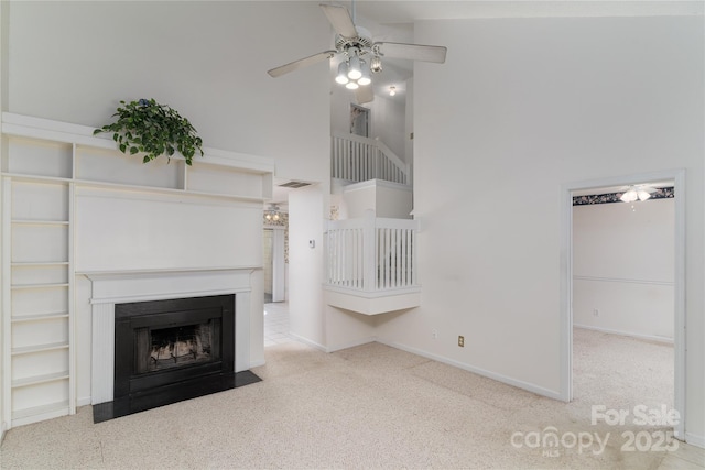 9006 Four Mile Creek Rd, Charlotte, NC 28277 - unfurnished living room featuring ceiling fan, carpet, a fireplace with flush hearth, baseboards, and a towering ceiling