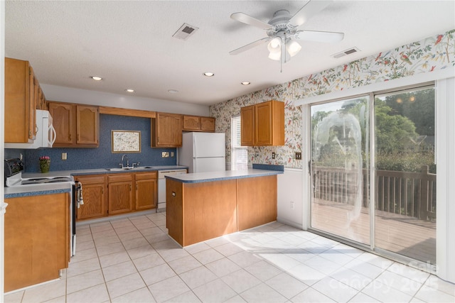 9006 Four Mile Creek Rd, Charlotte, NC 28277 - kitchen featuring white appliances, a sink, a peninsula, wallpapered walls, and ceiling fan
