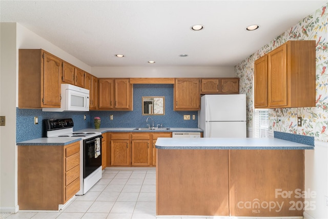 9006 Four Mile Creek Rd, Charlotte, NC 28277 - kitchen with white appliances, a sink, wallpapered walls, a peninsula, and brown cabinetry