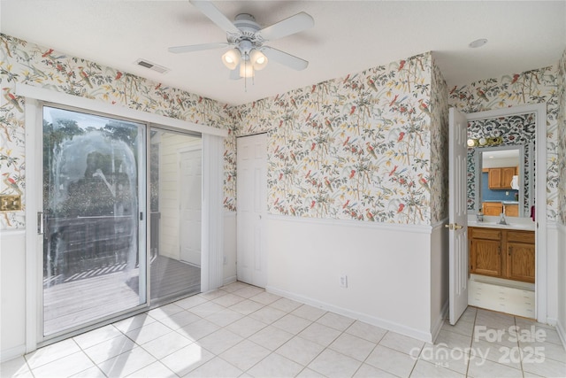 9006 Four Mile Creek Rd, Charlotte, NC 28277 - spare room featuring wallpapered walls, ceiling fan, light tile patterned floors, a sink, and baseboards