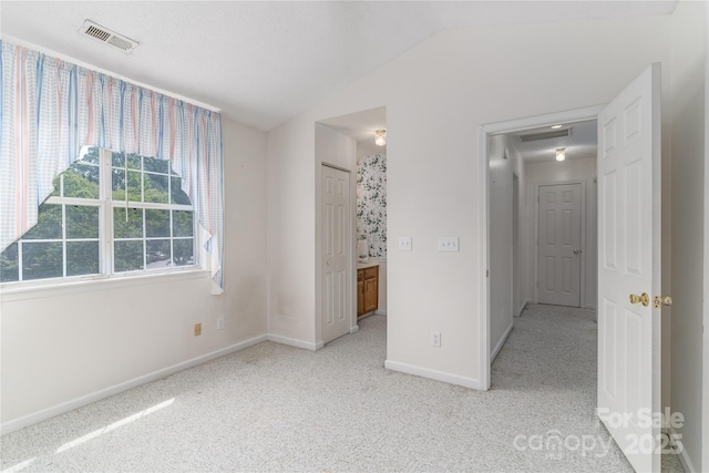 9006 Four Mile Creek Rd, Charlotte, NC 28277 - unfurnished bedroom with lofted ceiling, baseboards, carpet floors, and ensuite bath