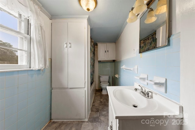 217 S Highland St, Gastonia, NC 28052 - full bathroom with tile walls, vanity, toilet, and shower / bath combination with curtain