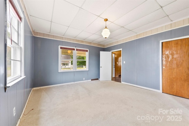 217 S Highland St, Gastonia, NC 28052 - unfurnished bedroom with carpet flooring, baseboards, a drop ceiling, and wooden walls