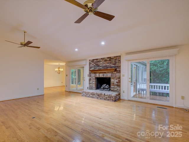 8 Sunrise Point Rd, Lake Wylie, SC 29710 - unfurnished living room with a ceiling fan, a chandelier, wood finished floors, a brick fireplace, and vaulted ceiling