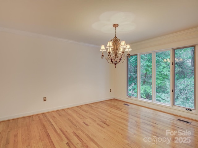 8 Sunrise Point Rd, Lake Wylie, SC 29710 - spare room featuring a chandelier, ornamental molding, light wood-style floors, and baseboards