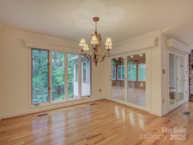 8 Sunrise Point Rd, Lake Wylie, SC 29710 - unfurnished dining area with light wood-style flooring, a chandelier, baseboards, and crown molding