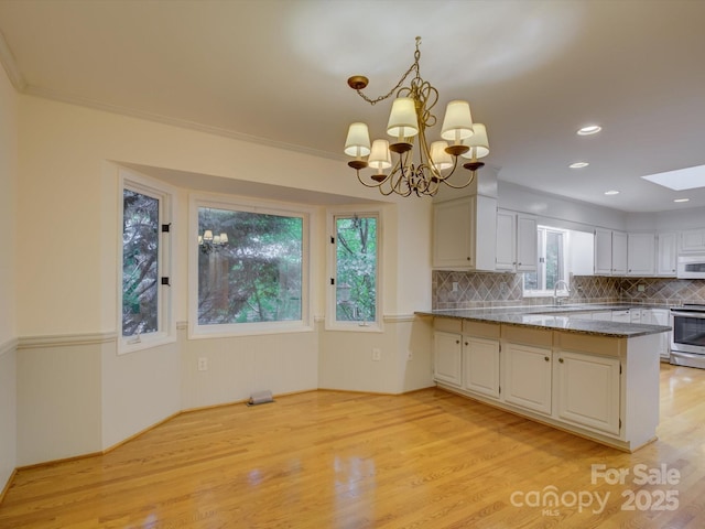 8 Sunrise Point Rd, Lake Wylie, SC 29710 - kitchen with electric stove, light wood-type flooring, a peninsula, decorative backsplash, and white microwave