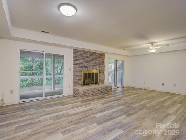 8 Sunrise Point Rd, Lake Wylie, SC 29710 - unfurnished living room with light wood finished floors, a ceiling fan, a brick fireplace, and baseboards