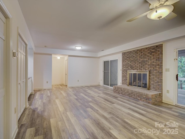 8 Sunrise Point Rd, Lake Wylie, SC 29710 - unfurnished living room featuring light wood-type flooring, a brick fireplace, a ceiling fan, and baseboards