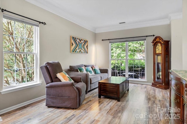 16018 Hollingbourne Rd, Huntersville, NC 28078 - living room with light wood-style flooring, plenty of natural light, ornamental molding, and baseboards