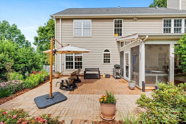 16018 Hollingbourne Rd, Huntersville, NC 28078 - back of house featuring a patio and a sunroom