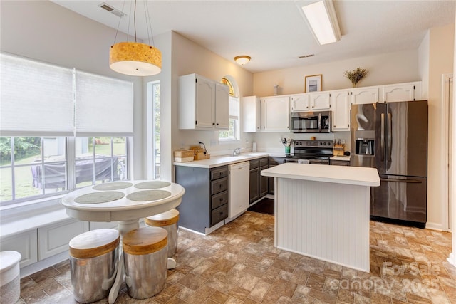 2024 Stonewyck Ave, Kannapolis, NC 28081 - kitchen featuring stainless steel appliances, white cabinetry, light countertops, and stone finish floors