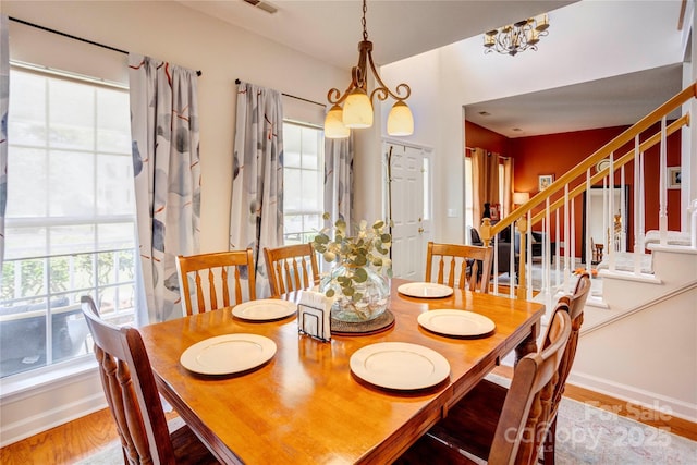 2024 Stonewyck Ave, Kannapolis, NC 28081 - dining space featuring healthy amount of natural light, wood finished floors, stairway, and baseboards