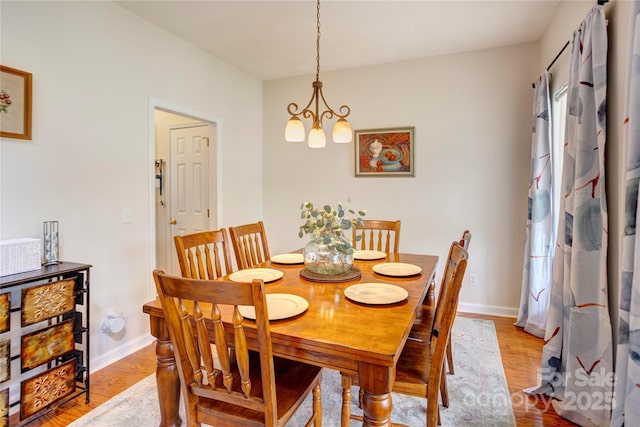 2024 Stonewyck Ave, Kannapolis, NC 28081 - dining space featuring a chandelier, light wood finished floors, and baseboards