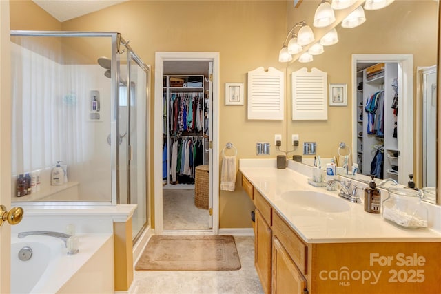 2024 Stonewyck Ave, Kannapolis, NC 28081 - full bathroom featuring a shower stall, vanity, a garden tub, and a walk in closet