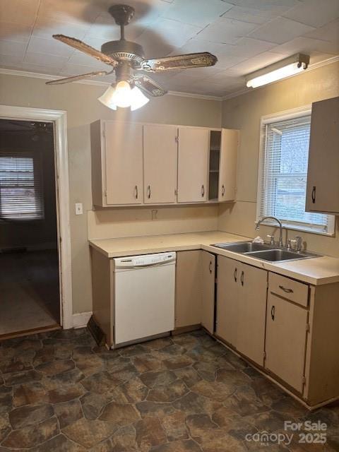 8000 Chapman St, Charlotte, NC 28216 - kitchen with white dishwasher, light countertops, a sink, ornamental molding, and stone finish floors