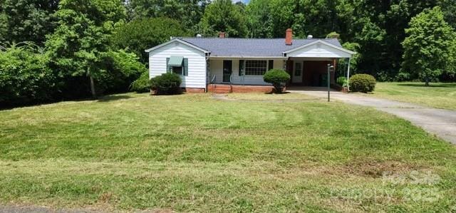 8000 Chapman St, Charlotte, NC 28216 - single story home featuring driveway, a front yard, an attached carport, covered porch, and a chimney