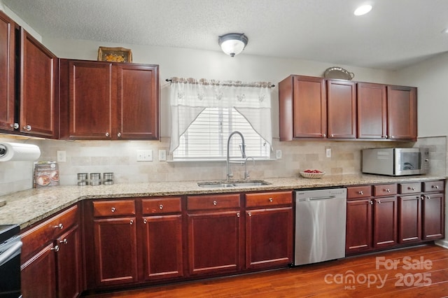 512 Nanny Point Dr, Monroe, NC 28110 - kitchen featuring stainless steel appliances, a sink, dark brown cabinets, and light stone counters