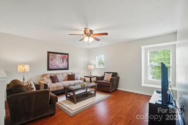 512 Nanny Point Dr, Monroe, NC 28110 - living area featuring healthy amount of natural light, wood finished floors, a ceiling fan, and baseboards