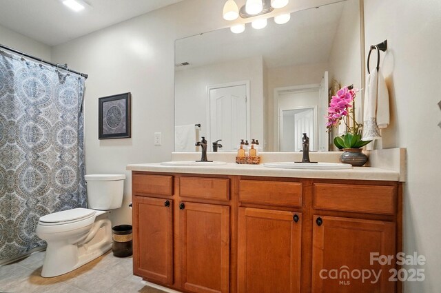 512 Nanny Point Dr, Monroe, NC 28110 - full bath featuring toilet, double vanity, tile patterned floors, and curtained shower