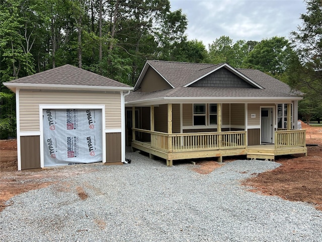 1987 Robert Rufty Ln, Catawba, NC 28609 - view of front of home featuring roof with shingles, a garage, covered porch, gravel driveway, and view of scattered trees
