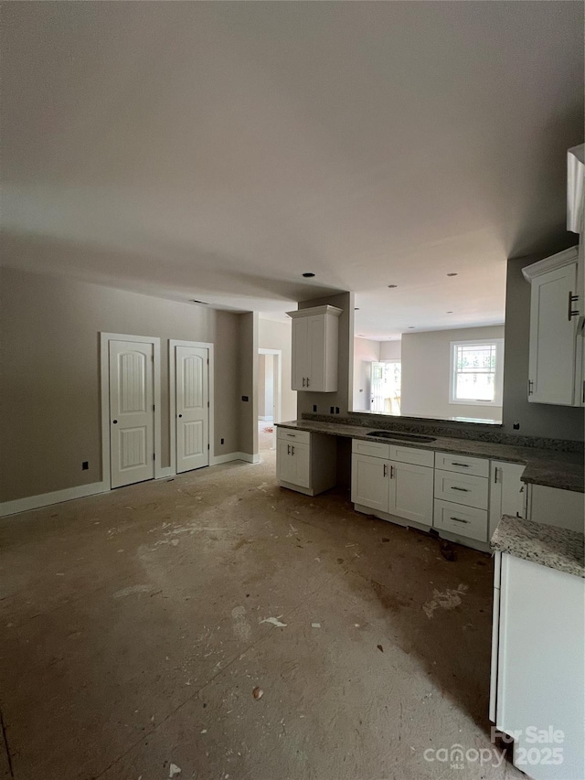 1987 Robert Rufty Ln, Catawba, NC 28609 - kitchen featuring white cabinets, baseboards, and cooktop