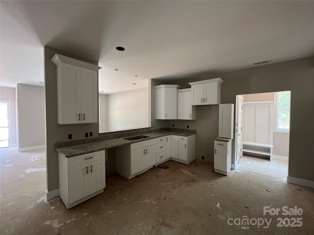 1987 Robert Rufty Ln, Catawba, NC 28609 - kitchen featuring white cabinets, healthy amount of natural light, a sink, and baseboards